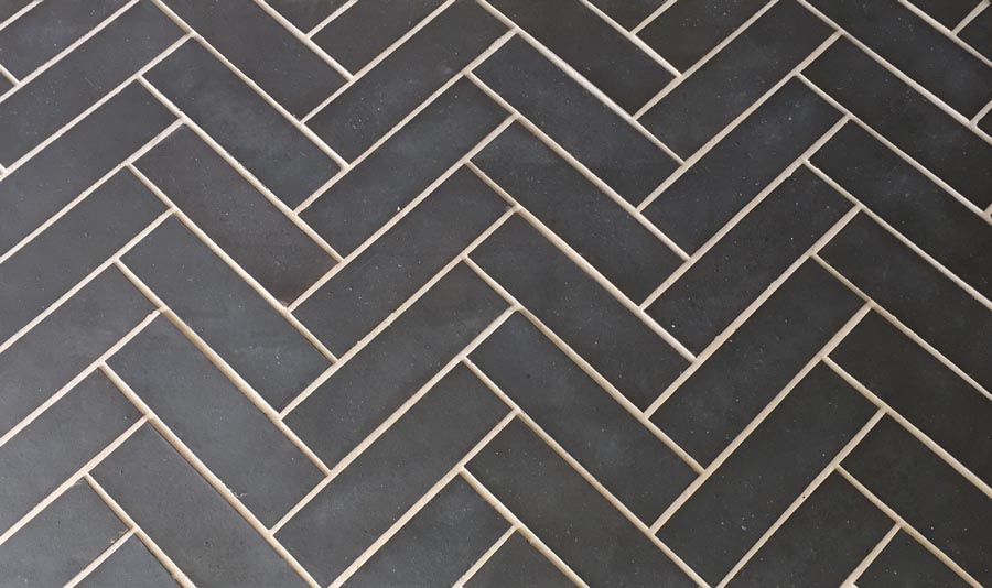 Brick sized quarry tiles laid in a herringbone pattern